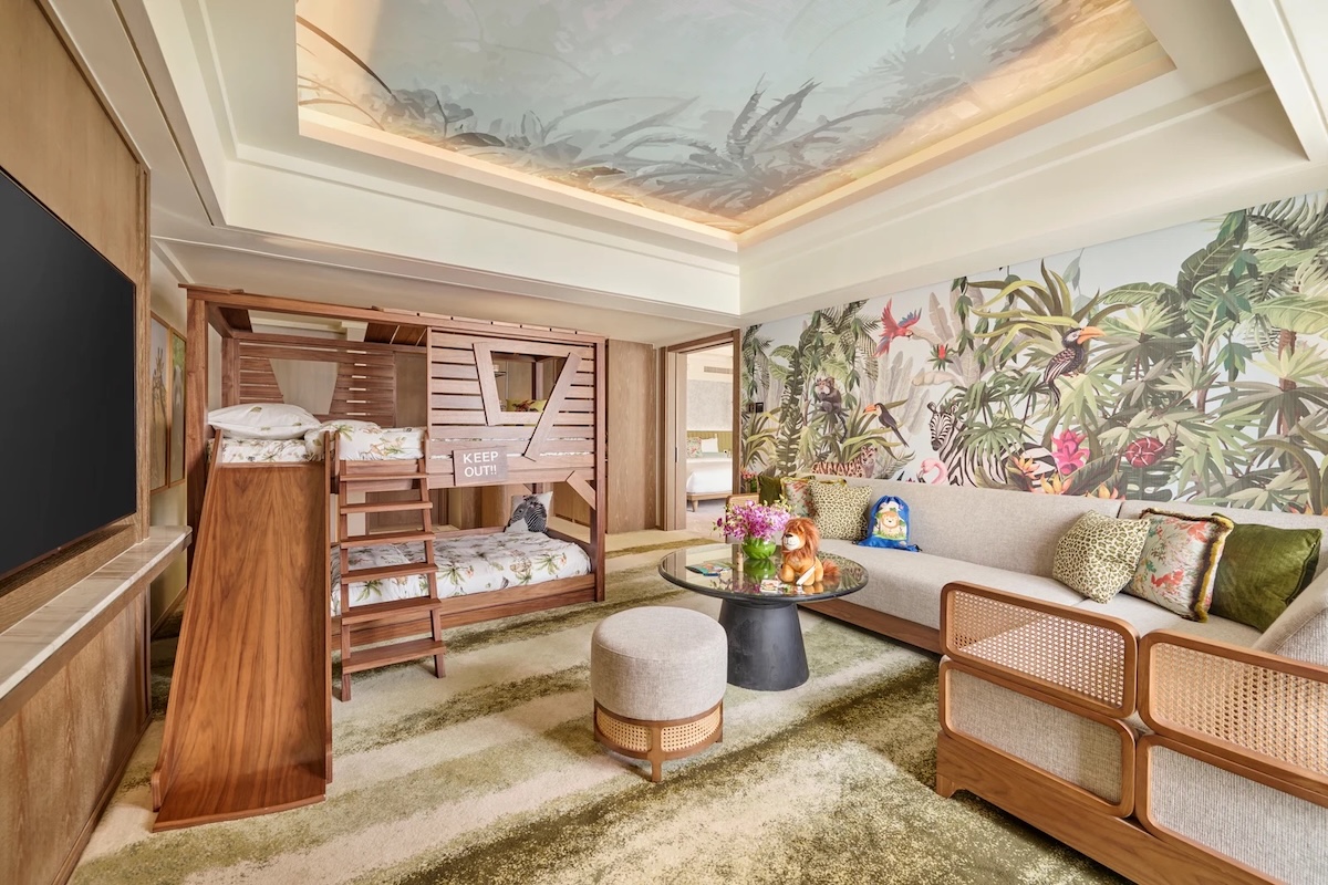 Mandarin Oriental Kids Suite Kids playing in a luxury themed hotel suite with a slide in Singapore.